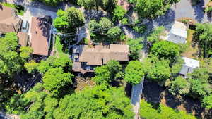 Aerial view of house with deck extended over the river