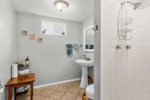 Bathroom featuring a tile shower and tile patterned floors