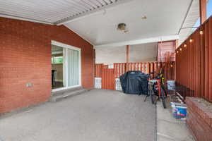 View of patio with a grill