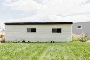 View of property exterior featuring a yard