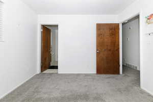 Unfurnished room featuring carpet floors and baseboards