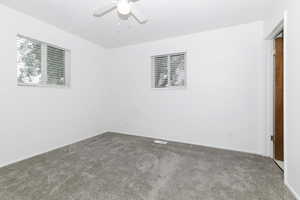 Spare room with carpet floors and a ceiling fan