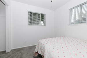 Carpeted bedroom featuring baseboards