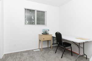 Carpeted home office with baseboards
