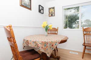 Dining room featuring wood finished floors and baseboards