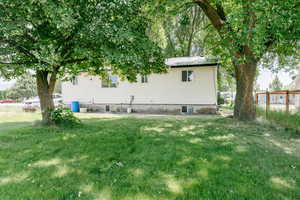 Rear view of property with a lawn