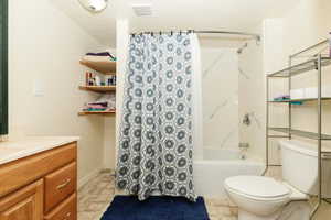 Full bathroom with vanity and shower / bath combo with shower curtain