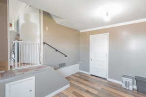 Stairway featuring wood finished floors and baseboards