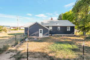 Back of property featuring a metal roof and a chimney