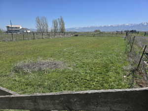 View of yard featuring a rural view and a mountain view