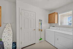 Washroom with washer and dryer and cabinet space