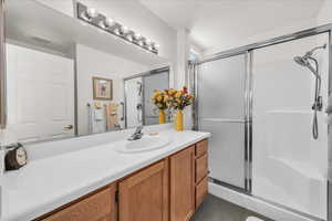 Bathroom featuring a stall shower and vanity