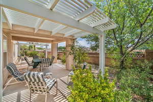 Fenced backyard featuring outdoor dining space, a pergola, and a patio