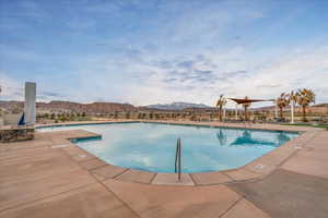 Community pool featuring a mountain view and a patio area