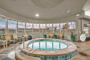 View of pool with a hot tub