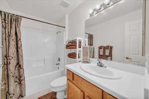 Bathroom with vanity, shower / bath combo, and tile patterned flooring