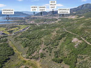 Aerial view of property's location with a water and mountain view