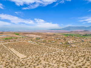 Overview of rural landscape featuring property parcel outlined and a mountain backdrop. Looking North