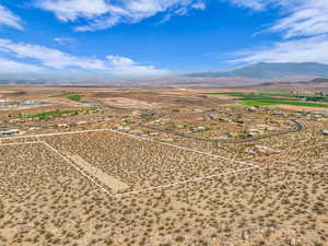 Overview of rural landscape featuring a mountainous background and property parcel outlined