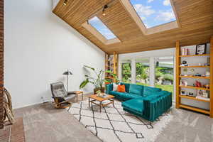 Living room with tongue-and groove vaulted ceilings and sunny skylights