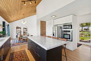 Kitchen with modern cabinets, breakfast bar area and white oak wood floors