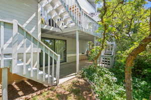 View of home's exterior featuring stairway, a patio area, and a deck
