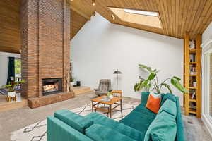 Living room with floor to ceiling brick fireplace