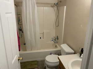 Full bath with shower / bath combination with curtain and vanity