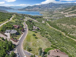 Aerial view of property's location featuring a water and mountain view