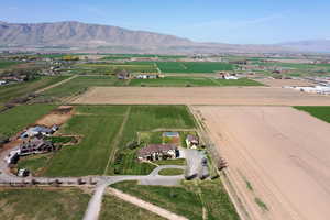 Aerial view of property's location with rural landscape and a mountain backdrop