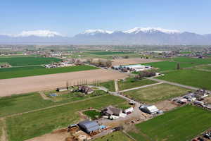 Aerial view of property's location with rural landscape and a mountainous background
