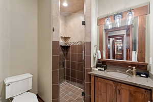Bathroom featuring a stall shower and vanity
