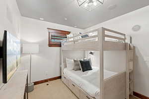 Carpeted bedroom featuring baseboards