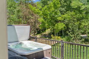 Deck with a hot tub and grilling area