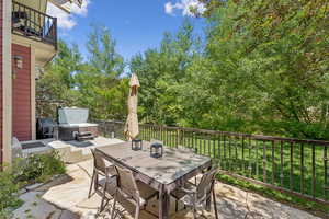 Patio / terrace with a hot tub, outdoor dining space, and a patio