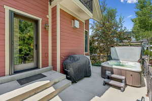 View of patio / terrace with a hot tub and area for grilling