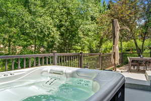 Deck featuring a hot tub and outdoor dining space
