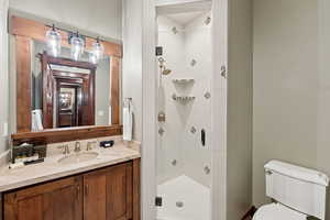 Bathroom with a shower stall and vanity