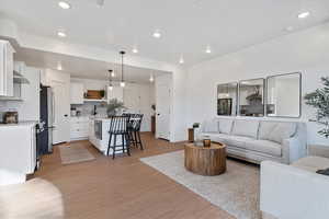 Living room featuring light wood-style floors and recessed lighting
