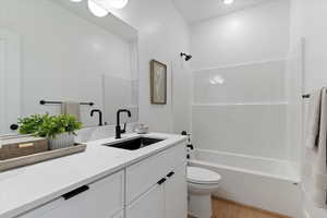 Full bathroom featuring vanity, shower / tub combination, and light wood finished floors