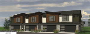 View of front of property with stone siding, a garage, and driveway