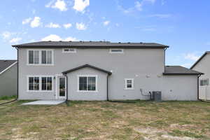 Rear view of property featuring a patio area, stucco siding, and a yard