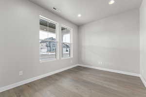 Spare room featuring wood finished floors and recessed lighting