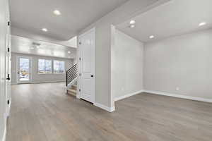 Spare room featuring stairway, recessed lighting, and light wood-style floors
