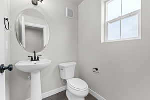 Bathroom with toilet and wood finished floors