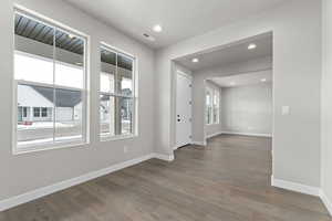 Unfurnished room with wood finished floors and recessed lighting