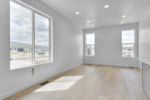 Empty room with recessed lighting and light wood-style flooring