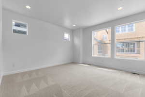 Spare room with light colored carpet and recessed lighting