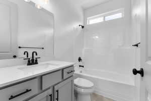 Bathroom with vanity and tub / shower combination