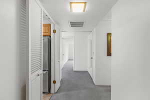 Hall featuring light carpet